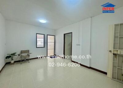 Spacious living room with tiled floor and natural lighting