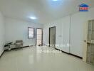 Spacious living room with tiled floor and natural lighting