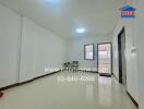 Spacious living room with white walls and tiled floor