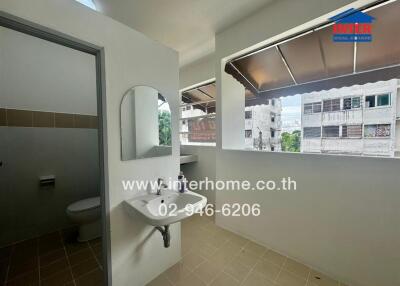 Bathroom with wall-mounted sink and mirror