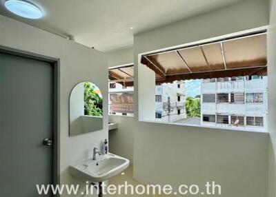 Well-lit bathroom with a sink and mirror