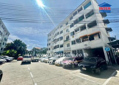 Exterior view of apartment building with parking lot