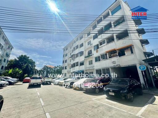 Exterior view of apartment building with parking lot