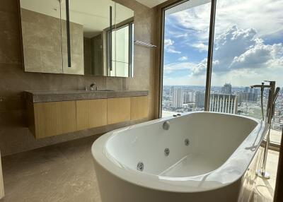 Luxurious bathroom with a large bathtub and a scenic city view