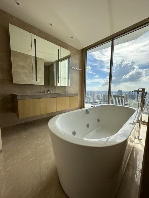 Luxurious bathroom with a large bathtub and a scenic city view