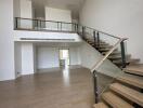 Spacious living area with modern staircase and wooden flooring