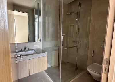 Modern bathroom with glass shower enclosure and vanity mirror