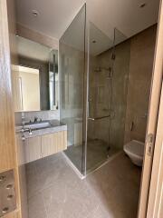 Modern bathroom with glass shower enclosure and vanity mirror