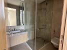 Modern bathroom with glass shower enclosure and vanity mirror