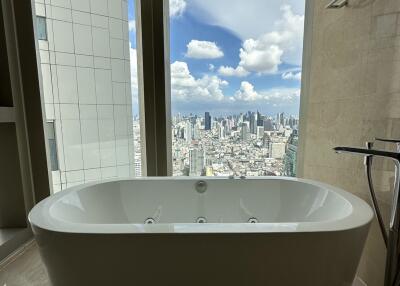 Modern bathroom with freestanding bathtub and city view