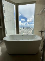 Modern bathroom with freestanding bathtub and city view