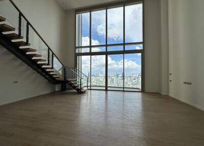 Spacious living room with large windows and city view