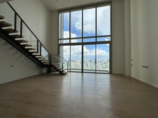 Spacious living room with large windows and city view