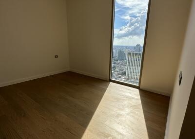 Empty room with wooden flooring and large window