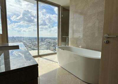 Modern bathroom with large window and city view