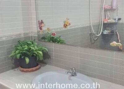 Bathroom with a sink, mirror, and shower