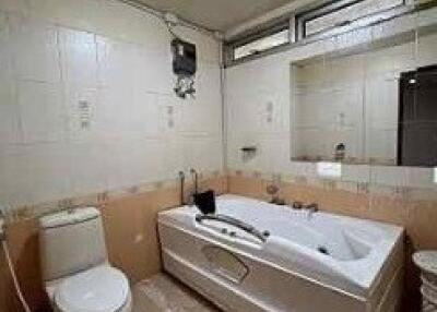 Spacious bathroom with bathtub and toilet