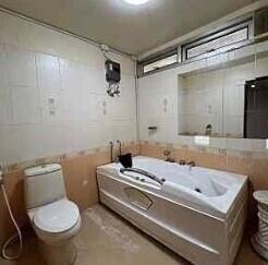 Spacious bathroom with bathtub and toilet