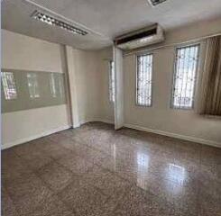 Empty room with windows, air conditioner and lighting fixtures