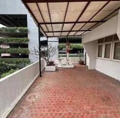 Spacious covered balcony with furniture