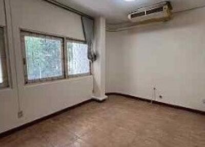 vacant living room with large windows and air conditioning unit