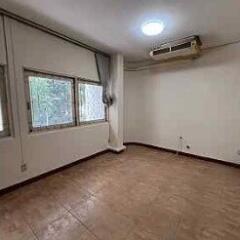 vacant living room with large windows and air conditioning unit