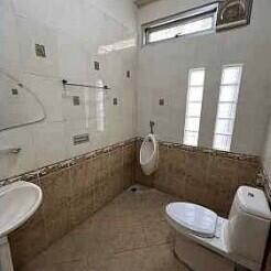 Modern bathroom with sink, toilet, and urinal