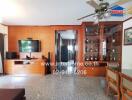 Spacious living room with wooden cabinetry and glass shelving