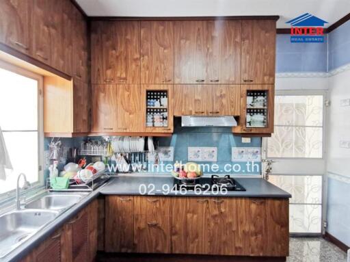 Spacious kitchen with wooden cabinets and modern appliances