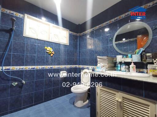 Modern bathroom with blue tiles and various accessories