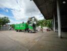 Commercial lot with truck and crane unloading materials