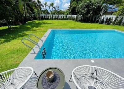 Backyard with pool and lawn