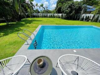 Backyard with pool and lawn