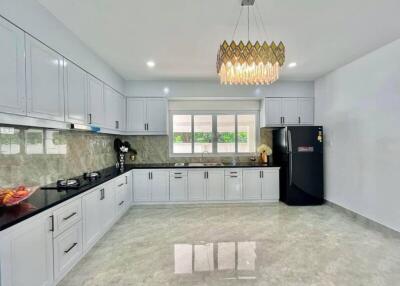 Modern kitchen with white cabinets and black countertops