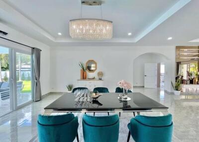 Bright dining room with modern decor and large chandelier