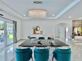 Bright dining room with modern decor and large chandelier