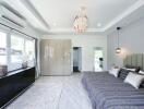 Modern airy bedroom with large window, stylish lighting, and ample storage.