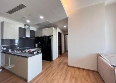 Modern kitchen with wooden flooring and open living space