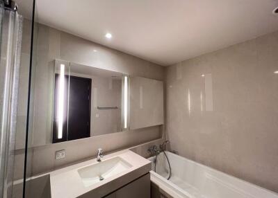 Modern bathroom with mirror, sink, and bathtub