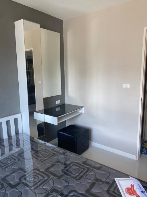 Modern bedroom with a wall-mounted desk and mirror