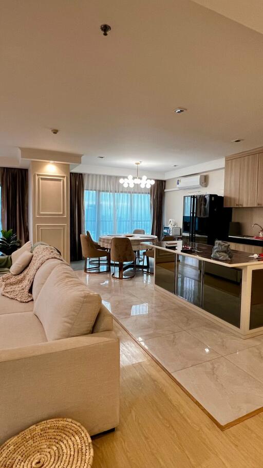 Spacious living room connected to an open kitchen area