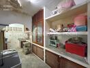 A cluttered kitchen with various items on the shelves