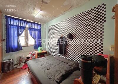 Bedroom with checkered accent wall and blue curtains