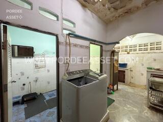 Laundry area with washing machine and sink