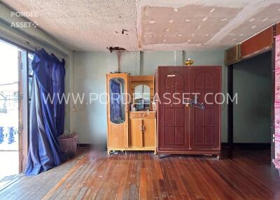 Living area with wooden floor and cabinets