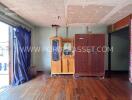 Living area with wooden floor and cabinets