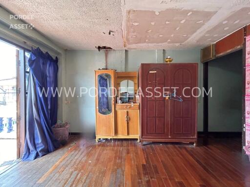 Living area with wooden floor and cabinets