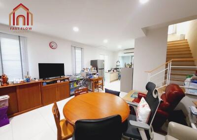 Living room with dining table, television, and access to kitchen