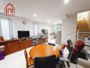 Living room with dining table, television, and access to kitchen