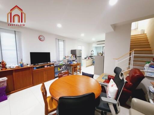 Living room with dining table, television, and access to kitchen